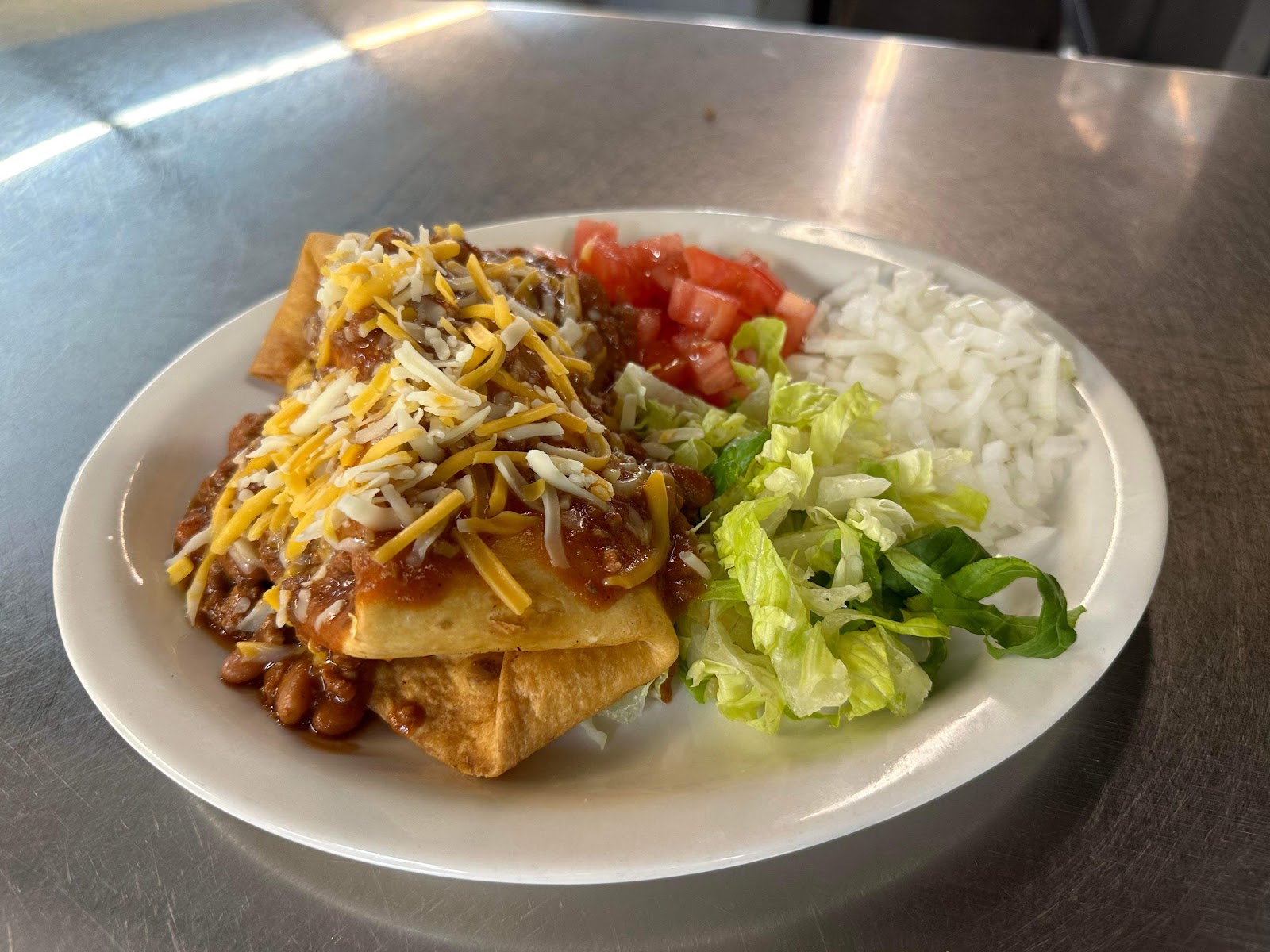Loaded chili cheese fries with lettuce, tomato and onions