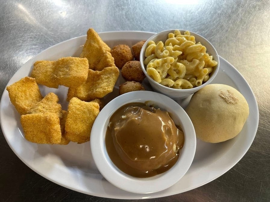 Catfish dinner with macaroni and cheese, hush puppies and mashed potatoes